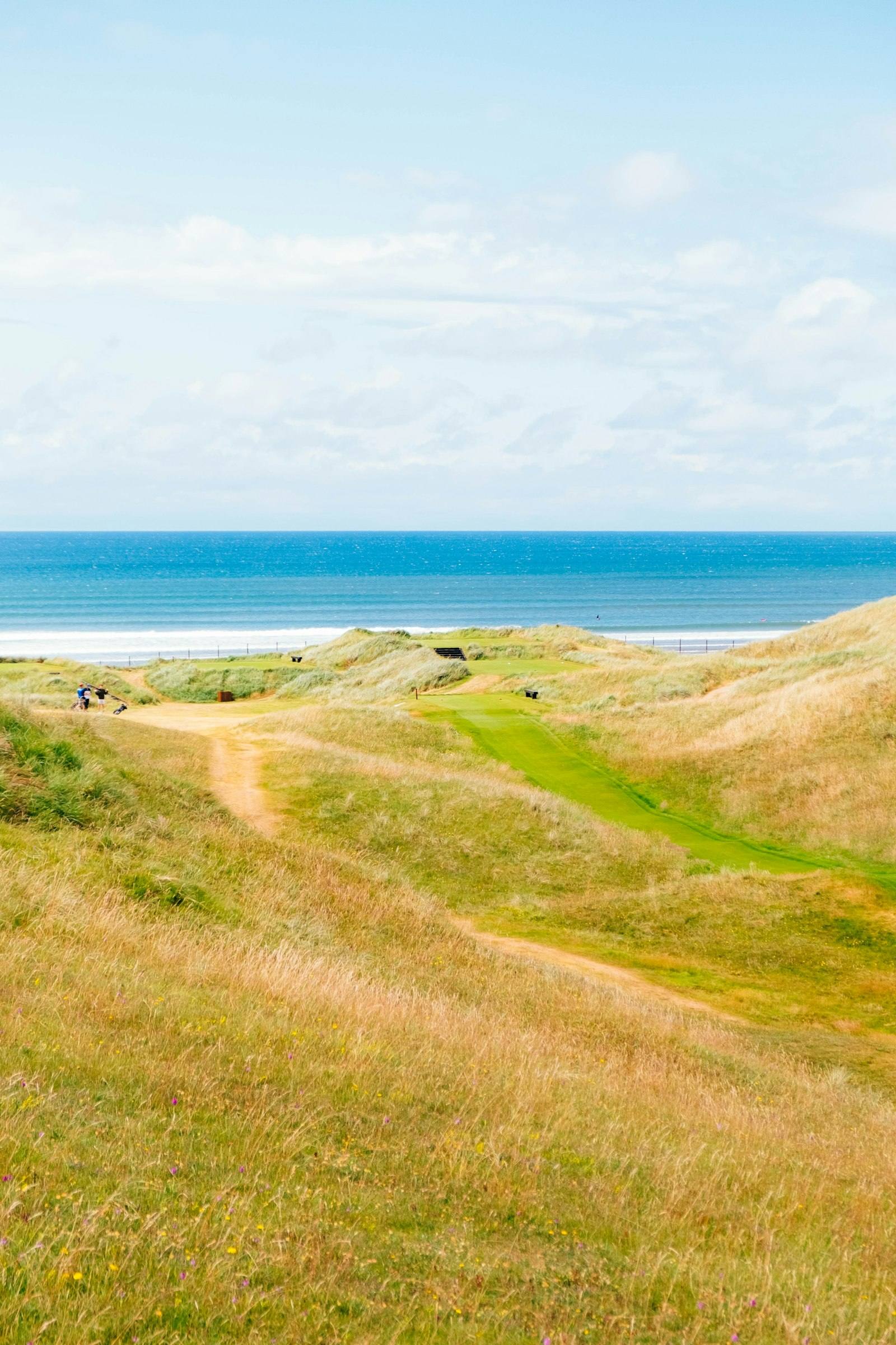A links fairway threading through the dunes toward the Atlantic on the Irish coast